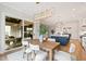 Bright dining room featuring modern lighting, wood floors, and sliding glass doors at 1629 Montvale Grant Way, Cary, NC 27519