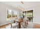 Dining room with large window, wood floors, and view of the outdoors at 1629 Montvale Grant Way, Cary, NC 27519