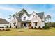 Beautifully landscaped home featuring a brick and siding exterior, and a covered front porch at 1629 Montvale Grant Way, Cary, NC 27519