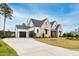 Stunning brick and siding home with a three car garage and a long concrete driveway at 1629 Montvale Grant Way, Cary, NC 27519