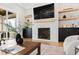 Elegant fireplace featuring custom shelving, modern cabinetry, decorative mantel, and stylish accents at 1629 Montvale Grant Way, Cary, NC 27519