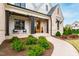 Charming front porch with decorative columns, stylish seating, meticulously maintained landscaping, and a winding walkway at 1629 Montvale Grant Way, Cary, NC 27519