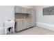 Functional garage area equipped with storage cabinets, a worktop, and utility sink at 1629 Montvale Grant Way, Cary, NC 27519
