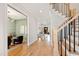 Spacious hallway featuring hardwood floors, access to living areas, and a view of the staircase at 1629 Montvale Grant Way, Cary, NC 27519