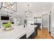 Modern kitchen boasts stainless steel appliances, farmhouse sink, and stunning light fixtures at 1629 Montvale Grant Way, Cary, NC 27519