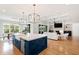 Open kitchen and living room with an island, hardwood floors, and coffered ceilings at 1629 Montvale Grant Way, Cary, NC 27519