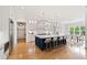 Open kitchen layout featuring a large island, seating, and stainless steel appliances, seamlessly connecting to the dining area at 1629 Montvale Grant Way, Cary, NC 27519