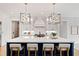 Spacious kitchen island with seating, complemented by pendant lighting and modern appliances for a chef-inspired design at 1629 Montvale Grant Way, Cary, NC 27519