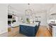Bright, open kitchen with a large island, white cabinets, stainless steel appliances, and seamless connection to the living area at 1629 Montvale Grant Way, Cary, NC 27519