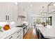 Gourmet kitchen featuring a large island, white cabinets, stainless appliances, and modern fixtures for cooking and entertaining at 1629 Montvale Grant Way, Cary, NC 27519