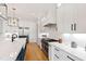 Chef's kitchen with stainless steel appliances, white cabinets, and a spacious island, perfect for culinary enthusiasts at 1629 Montvale Grant Way, Cary, NC 27519