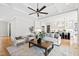 Bright living room with coffered ceiling, open layout to kitchen, hardwood floors, and modern decor at 1629 Montvale Grant Way, Cary, NC 27519