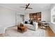 Bright living room featuring a stylish white sofa, ceiling fan, and convenient bar area for entertaining at 1629 Montvale Grant Way, Cary, NC 27519