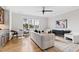 Inviting living room with a white sofa, accent chairs, and a view of the outside at 1629 Montvale Grant Way, Cary, NC 27519