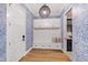 Inviting mudroom features a built-in bench with storage, coat hooks, and stylish wallpaper at 1629 Montvale Grant Way, Cary, NC 27519