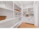 Spacious pantry featuring custom shelving, providing ample space for organized food and kitchen storage at 1629 Montvale Grant Way, Cary, NC 27519