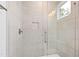 Modern tiled shower featuring glass door and window providing natural light at 1629 Montvale Grant Way, Cary, NC 27519