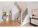 Elegant staircase with wooden treads, black iron railings, and stylish millwork leading to the upper level at 1629 Montvale Grant Way, Cary, NC 27519