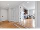 Hallway with hardwood floors leading to a wet bar and small dining area at 1629 Montvale Grant Way, Cary, NC 27519
