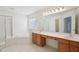 Bathroom featuring a corner soaking tub, glass enclosed shower, and a vanity with double sinks at 1903 Yellowwood Ln, Durham, NC 27712