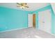 Well-lit bedroom boasting plush carpets, painted accent wall, ceiling fan, and a closet for storage at 1903 Yellowwood Ln, Durham, NC 27712
