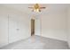 Bedroom featuring ceiling fan, carpeting, and double closets with doors to other rooms at 1903 Yellowwood Ln, Durham, NC 27712