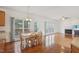 Dining area with large windows and french doors connects to adjacent living room with fireplace at 1903 Yellowwood Ln, Durham, NC 27712