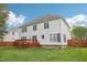 Back exterior showcasing a well-maintained yard, wooden fence, deck, and an inviting, neutral-toned home at 1903 Yellowwood Ln, Durham, NC 27712