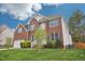 Two-story brick home with blue shutters, manicured lawn, and attached two car garage at 1903 Yellowwood Ln, Durham, NC 27712
