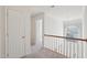 Hallway with wood railing and chandelier, leading to other rooms at 1903 Yellowwood Ln, Durham, NC 27712