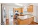 Well-equipped kitchen with stainless steel appliances, wood cabinets, and peninsula island counter at 1903 Yellowwood Ln, Durham, NC 27712