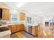 Kitchen with stainless steel appliances, wooden cabinetry, and an adjacent eat-in area and fireplace at 1903 Yellowwood Ln, Durham, NC 27712