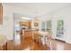 Open-concept kitchen with a dining area, wooden cabinets, stainless steel appliances, and hardwood flooring at 1903 Yellowwood Ln, Durham, NC 27712
