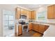 Beautiful kitchen with stainless steel appliances, ample counter space, and wood cabinetry at 1903 Yellowwood Ln, Durham, NC 27712