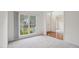 Bright living room with large windows and neutral carpet at 1903 Yellowwood Ln, Durham, NC 27712