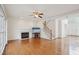 Inviting living room showcases a fireplace, hardwood flooring, and staircase with white spindles and wood handrail at 1903 Yellowwood Ln, Durham, NC 27712