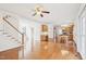 Open living room features hardwood floors, a staircase, and seamlessly connects to the kitchen and dining area at 1903 Yellowwood Ln, Durham, NC 27712