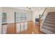 Bright living room featuring hardwood floors, large window, and fireplace with staircase on the right at 1903 Yellowwood Ln, Durham, NC 27712