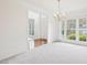 Open-concept living room with chandelier and abundant natural light at 1903 Yellowwood Ln, Durham, NC 27712