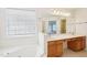 Vanity in bathroom with a white sink and neutral toned wood cabinets and drawers at 1903 Yellowwood Ln, Durham, NC 27712