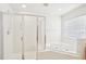 Well-lit bathroom features glass enclosed shower and corner whirlpool tub at 1903 Yellowwood Ln, Durham, NC 27712