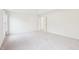 Spacious and light-filled main bedroom shows neutral walls and door to another room at 1903 Yellowwood Ln, Durham, NC 27712