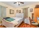 Cozy bedroom with hardwood floors and natural light and standard furnishings at 201 E End Ave, Durham, NC 27703