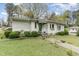 View of a charming single-story home featuring a welcoming front yard with mature landscaping at 201 E End Ave, Durham, NC 27703