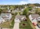 An aerial view shows the home, neatly manicured lawn, driveway, and surrounding neighborhood at 203 Grassy Point Rd, Apex, NC 27502