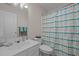 A bathroom featuring a single sink vanity with a shower and toilet at 203 Grassy Point Rd, Apex, NC 27502