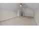 A light and airy bedroom features neutral carpet, light-colored walls and ceiling fan at 203 Grassy Point Rd, Apex, NC 27502