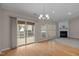 Dining room with a fireplace, access to the screened porch, and hardwood flooring at 203 Grassy Point Rd, Apex, NC 27502