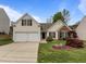 Charming home featuring well-maintained landscaping, a two-car garage, and classic architectural details at 203 Grassy Point Rd, Apex, NC 27502