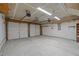 Spacious two-car garage featuring concrete flooring and ample lighting at 203 Grassy Point Rd, Apex, NC 27502